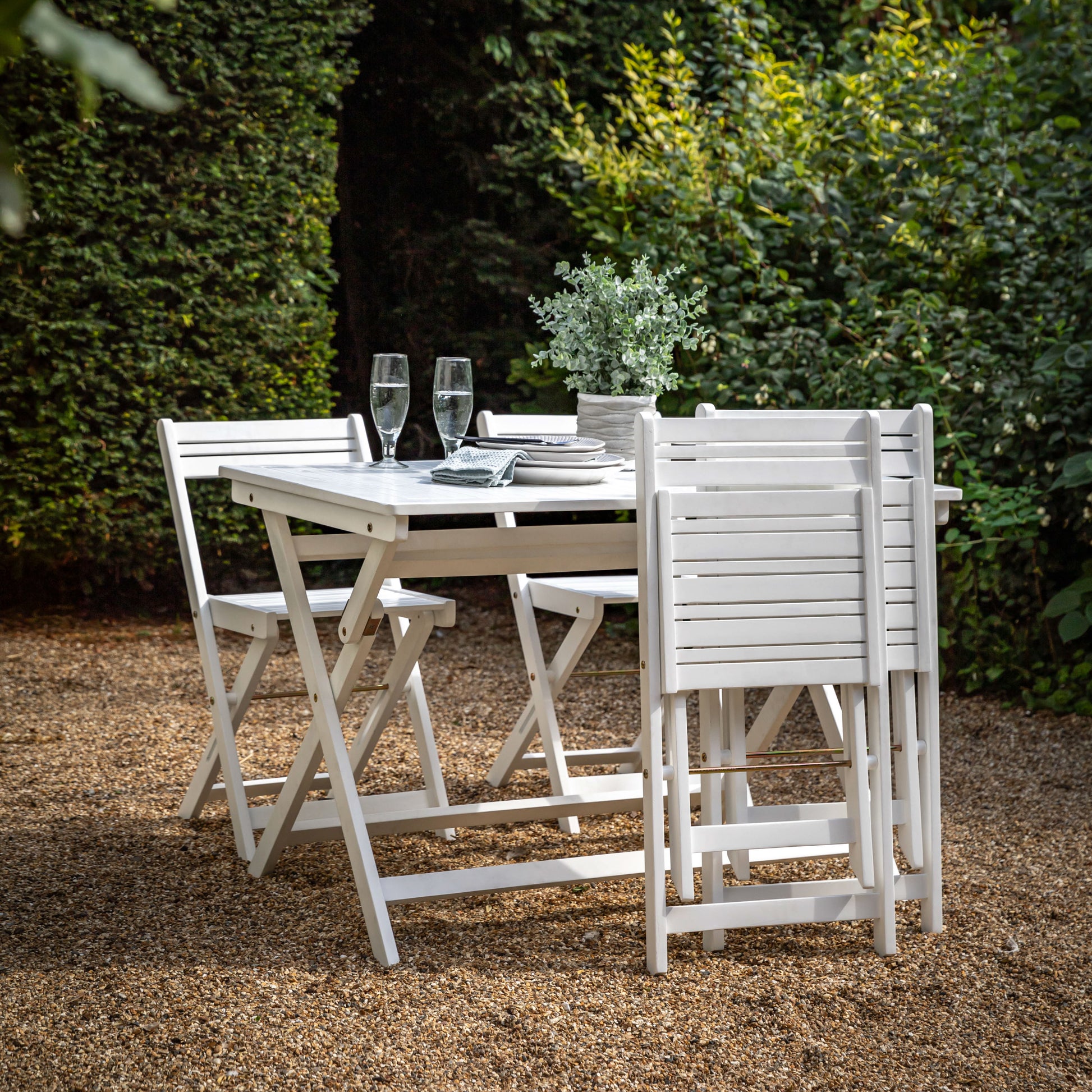 Gallery Garden Lindos Dining Set in White features a table with slatted top and 4 chairs, all can be folded for easy storage