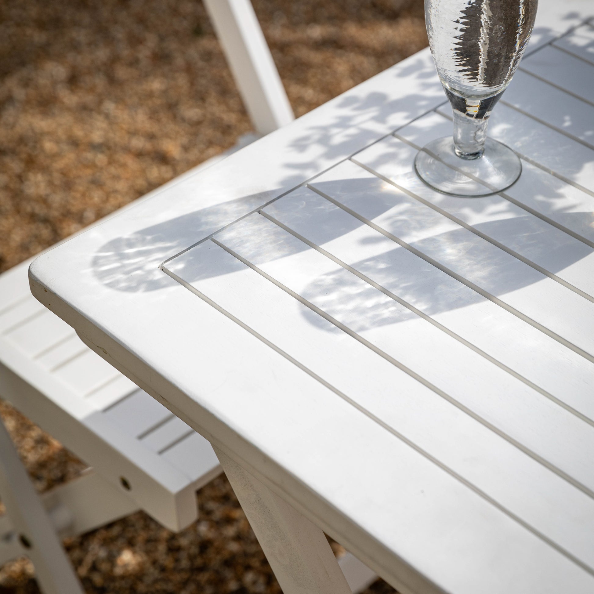 Gallery Garden Lindos Foldaway Dining Set in White features 4 chairs and a table with slatted white painted top