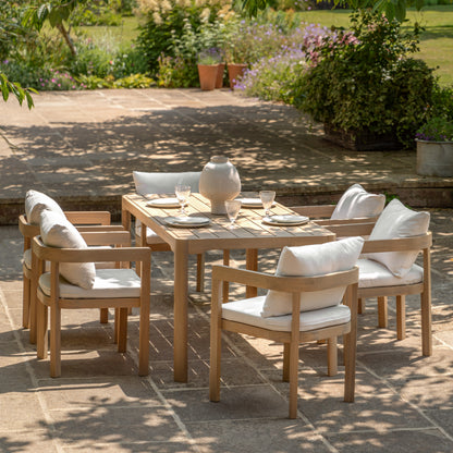 Gallery Garden Madeira 6 Seater Dining Set features a large acacia wood dining table with grooved table top and curved legs. The chairs also have a modern curved design with natural coloured seat pads and back cushions