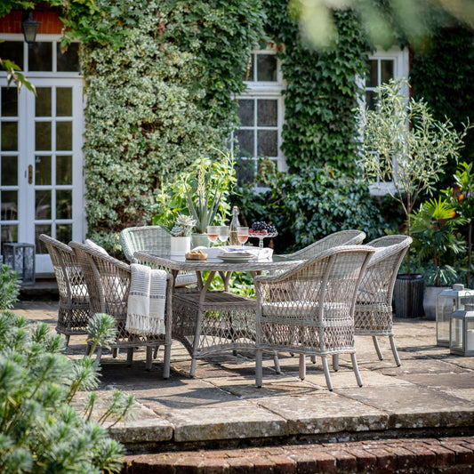 Gallery Garden Menton 6 Seater Oval Dining Set in Stone coloured PE rattan with a glass topped table and 6 armchairs with padded cushions