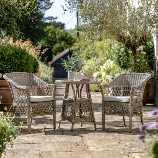 Gallery Garden Menton Bistro Set features a glass topped small table and 2 armchairs with seat pads, in Stone coloured PE rattan and aluminium frames