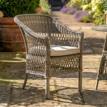 Gallery Garden Menton Bistro Set in Stone features 2 armchairs and a small glass topped table