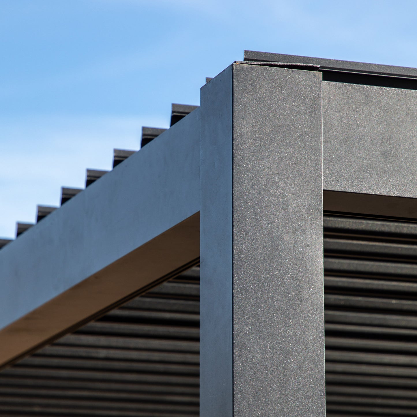 Gallery Garden Messina Pergola in Black aluminium with an adjustable louvred roof system operated by a handle winder, with a watertight seal and integrated drainage channels 