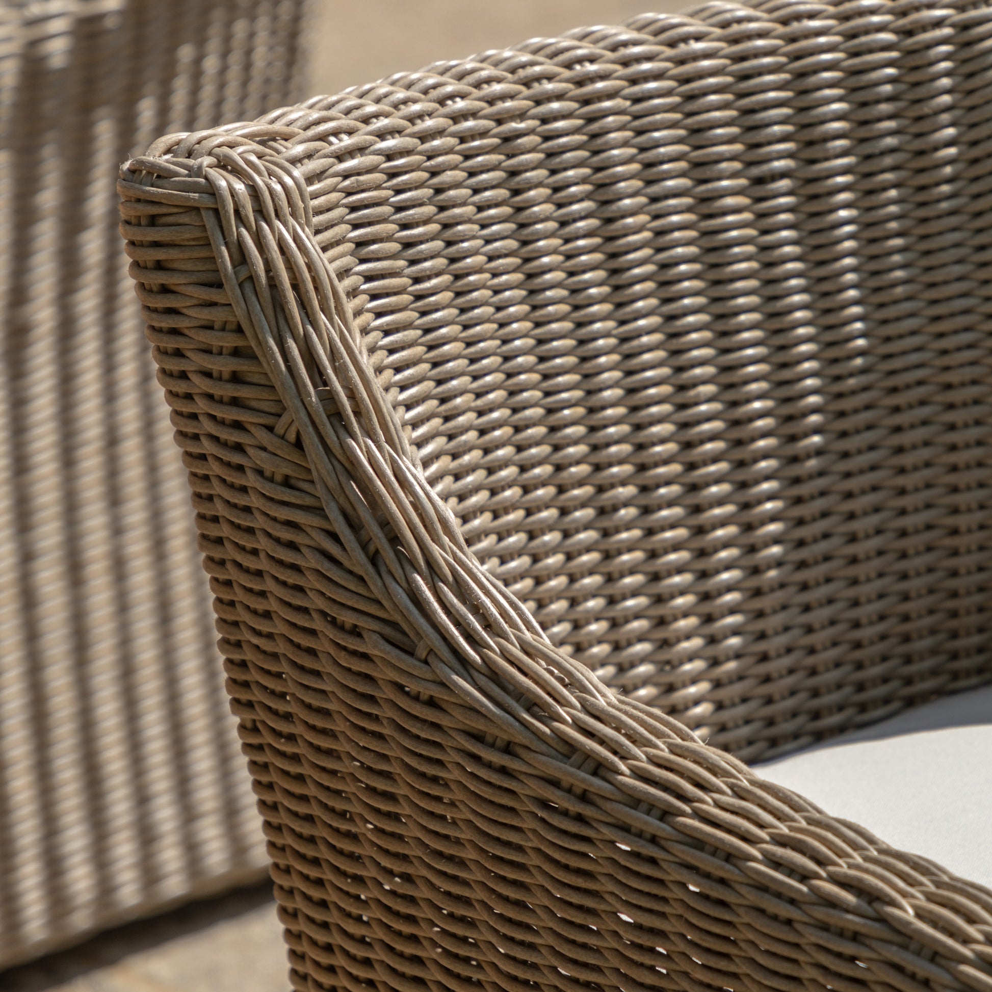Gallery Garden Pair of Chatsworth Dining Chairs crafted from durable woven plastic wicker  with gently sloping arms and plush seat cushions 