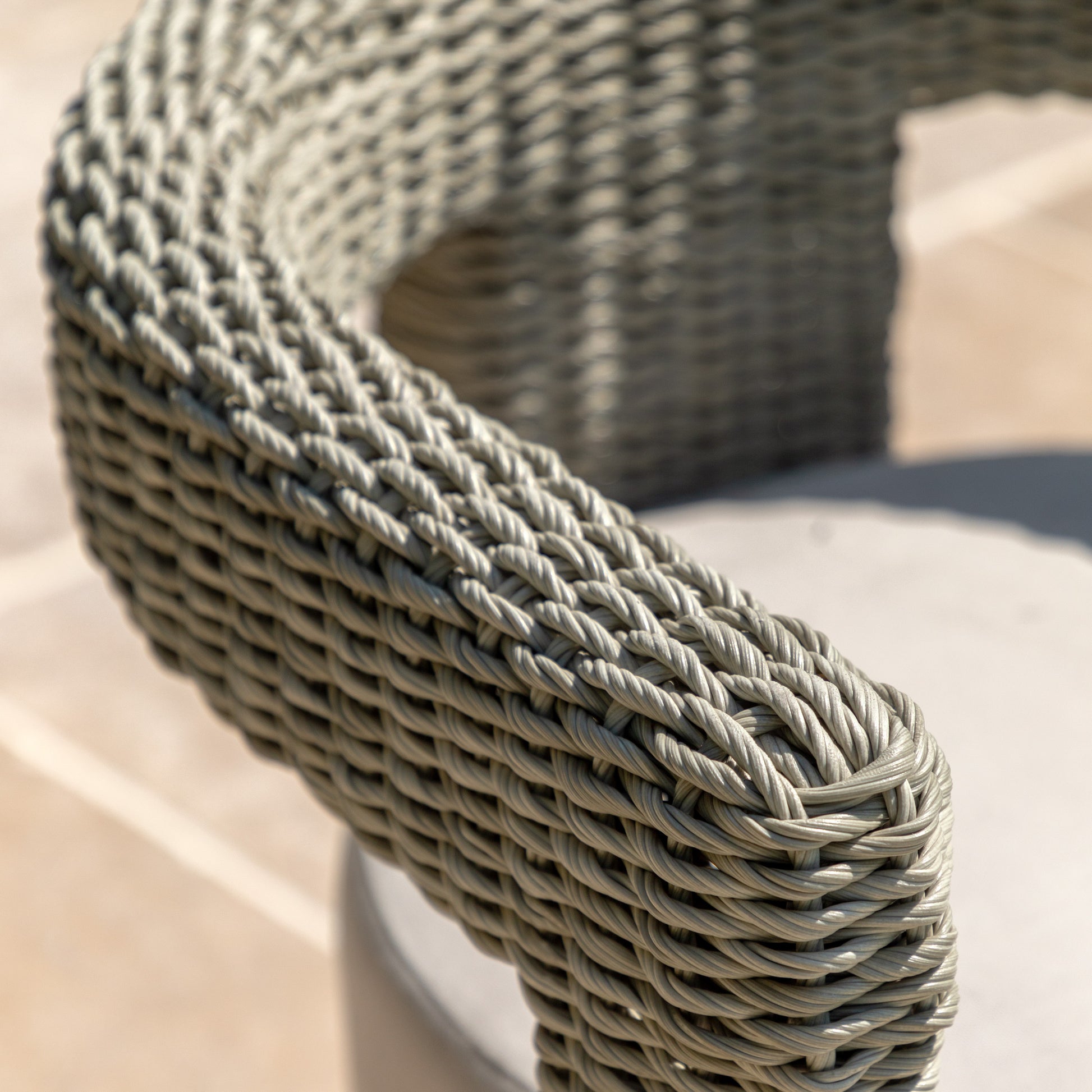 Gallery Garden Pair of Hvar Dining Chairs crafted from grey toned wicker with a curved cut-out back design and a thick padded seat cushion