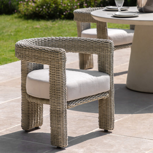Gallery Garden Pair of Hvar Wicker Dining Chairs in a grey tone, with curved cut-out back design and a generously padded seat cushion