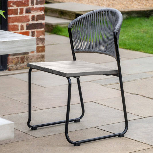 Gallery Garden Pair of Taranto Dining Chairs featuring a grey toned acacia wood seat, black metal frame and woven rope backrest 