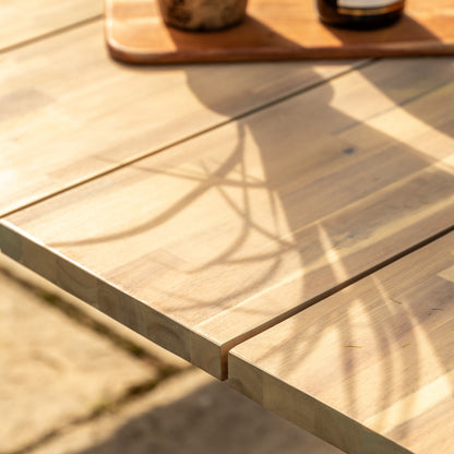 Gallery Garden Ponza Dining Table crafted from a warm, natural acacia wood with black metal legs