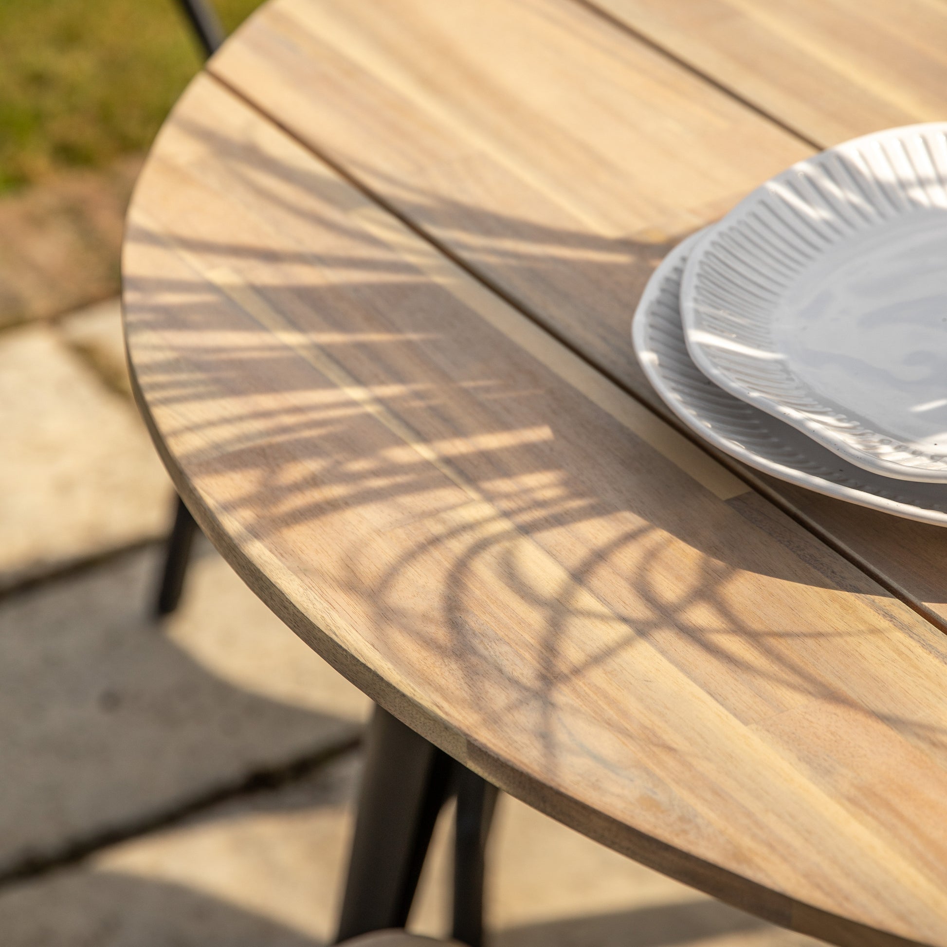 Gallery Garden Ponza Round Dining Table can seat up to 4 people and features a warm natural wood table top with dark metal legs