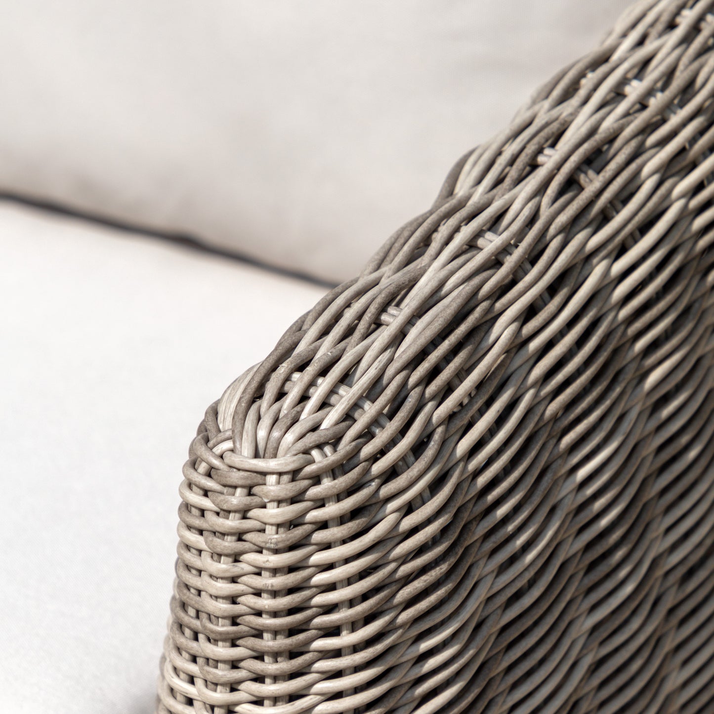 Gallery Garden Positano Armchair made from a resilient woven plastic wicker and complemented by natural generously padded cushions