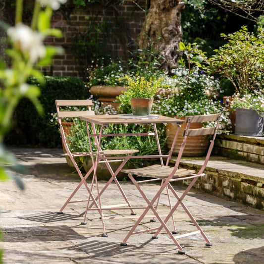 Gallery Garden Ronda Bistro Set features a folding metal and acacia wood table and 2 matching chairs with slatted wood seat in a rose pink colour