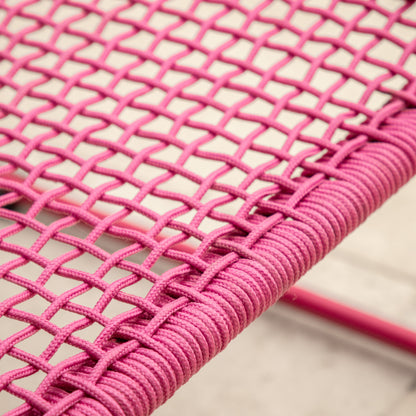 Gallery Garden Sassano Lounge Chair with Footstool in Pink features a robust steel frame with woven rope seat