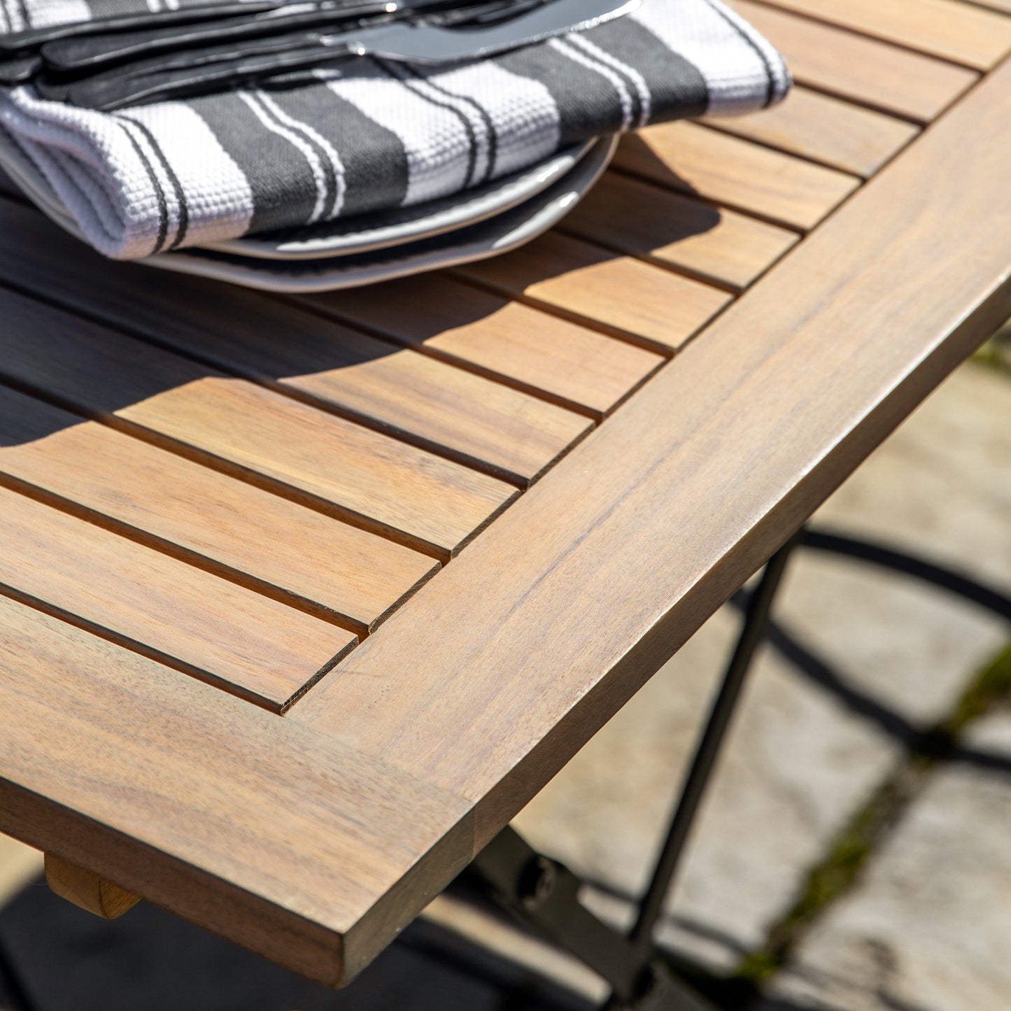 Gallery Garden Valetta 4 Seater Folding Dining Set features a rectangular table with folding metal legs and a slatted acacia wood table top 