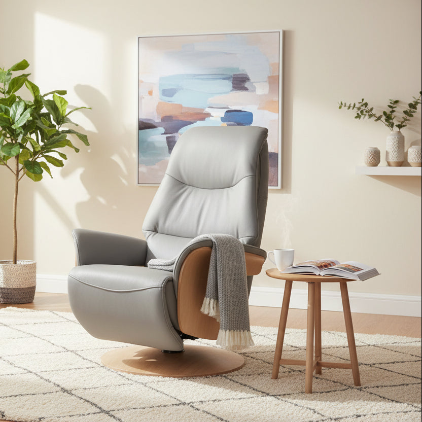 The Global Furniture Alliance Iowa Swivel and Recliner Chair in Pale Grey leather and a light wood arm and base, with an integrated footstool