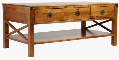 Laura Ashley Balmoral 3 Drawer Coffee Table in Honey birch wood features 3 top storage drawers with brass handles, underneath shelf space with cross-frame side detailing, and brass corner brackets