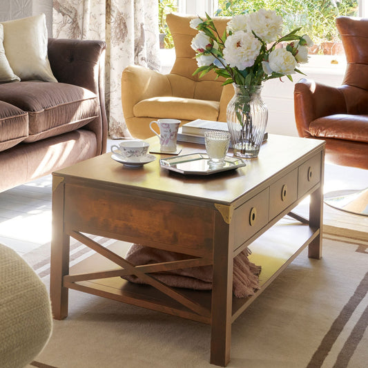 Laura Ashley Balmoral 3 Drawer Coffee Table in Honey birch wood features cross-frame side detail, 3 storage drawers with brass handles and an underneath shelf 