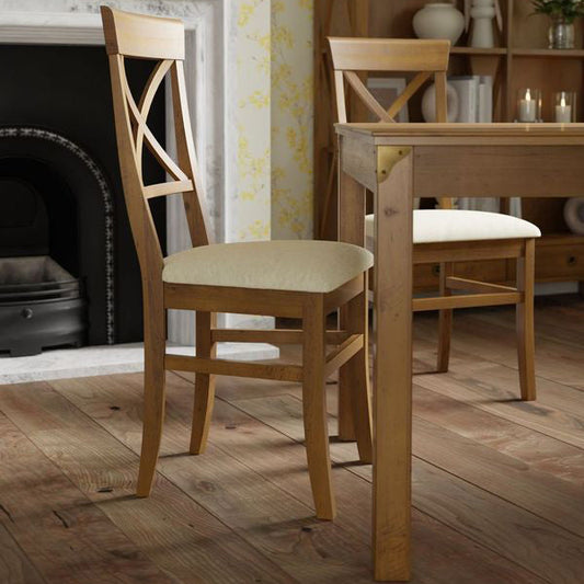 Laura Ashley Balmoral pair of dining chairs with traditional cross-back styling, tapered wooden legs and neutral upholstered seat pads.