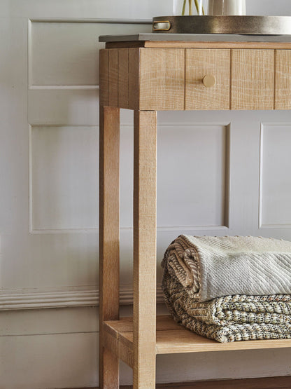 Laura Ashley Braystone console table with a grey stone top, made from solid oak with drawers and shelf