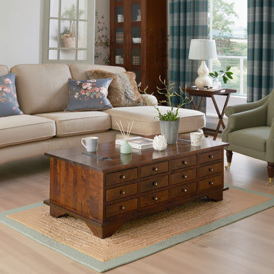 Laura Ashley Garrat 12 Drawer Coffee Table features a lift up table top for additional storage and 12 drawers with brushed metal handles, crafted from birch wood in a deep chestnut finish 