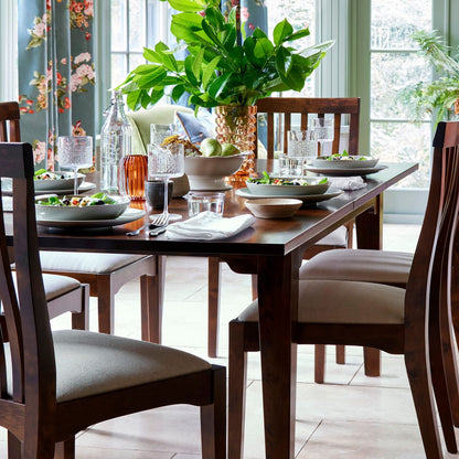 Laura Ashley Garrat rectangular extending dining table in chestnut finish with solid wood construction and traditional styling.
