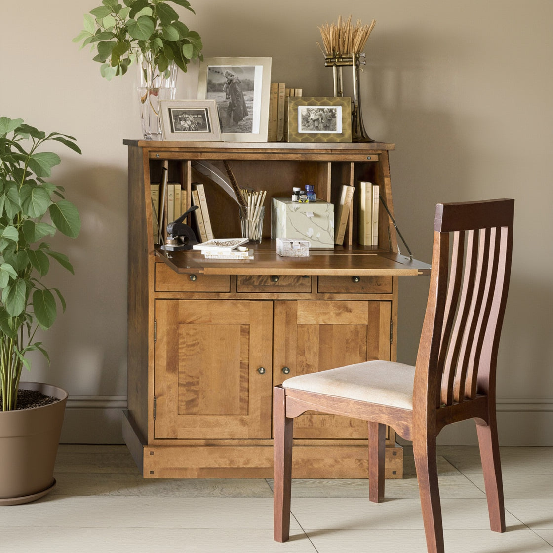 Laura Ashley Garrat traditional bureau desk featuring fold-down workspace, three drawers and lower cupboards
with metal knobs, in a honey birch wood finish