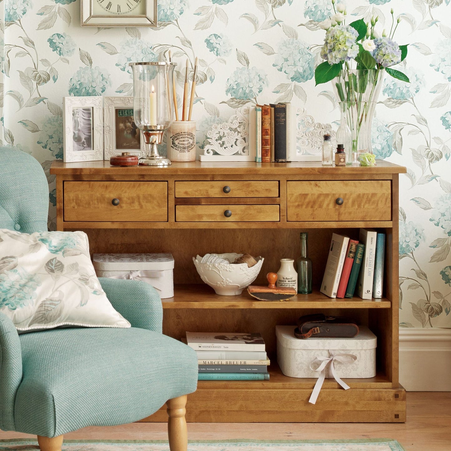 Laura Ashley Garrat Honey 4 Drawer Console Table features 2 shelves and 4 top drawers with metal handles