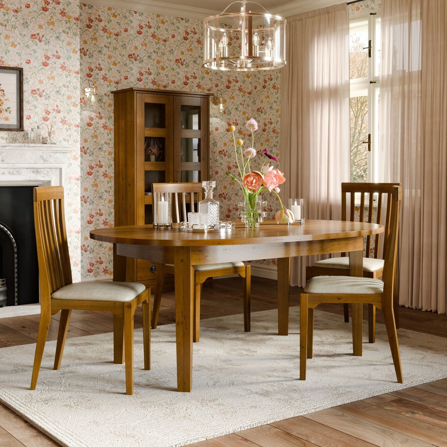 Laura Ashley Garrat oval extending dining table in honey finish with solid wood construction and traditional styling can seat 6-8 people.