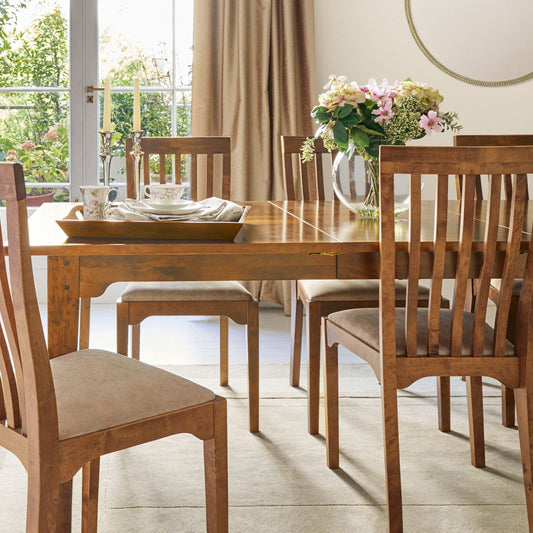 Garrat Honey upholstered dining chairs from Laura Ashley with classic slatted backs, warm wood finish and cushioned fabric seats.