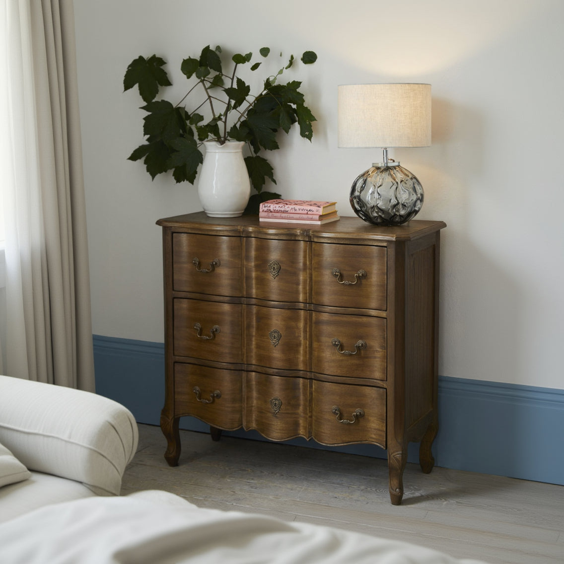 Laura Ashley Montpellier 3 drawer chest in aged walnut featuring curved French styling, decorative brass handles, scalloped base and elegant cabriole legs.