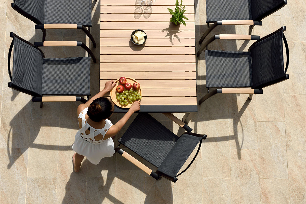 Panama 6 Seat Dining Set features a rectangular table with slatted wood effect top and a black aluminium frame, and 6 black aluminium chairs with textilene fabrics seats