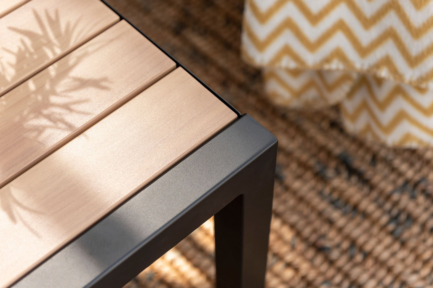 Panama Corner Set features a corner sofa and coffee table in a Black aluminium frame with a slatted wood-effect table top