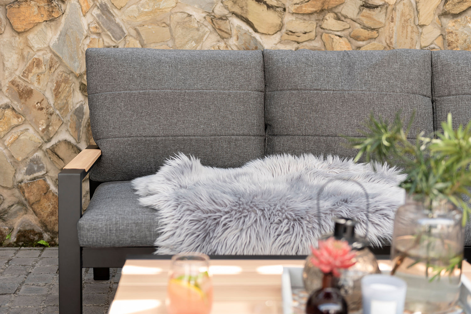 Panama Corner Set features a Black aluminium frame with wood-effect armrest detail and grey padded cushions