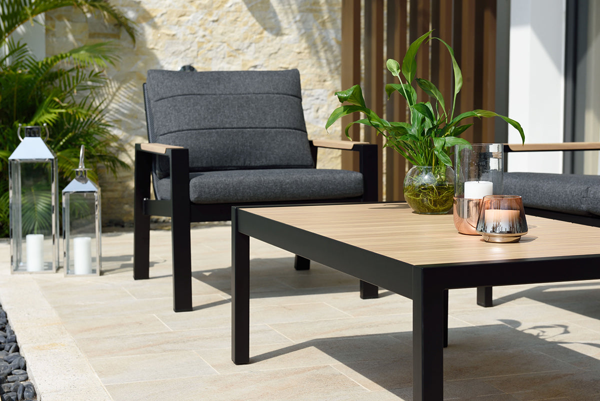 Panama Lounge Set features 2 armchairs, a 3 seater sofa and a coffee table with wood-effect top and black aluminium frame, the chairs have charcoal grey padded seat and back cushions