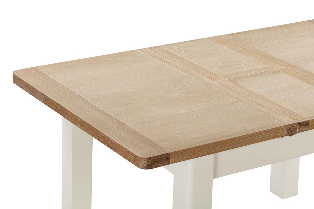 Papaya Foxington 120cm-153cm Extending Dining Table features an off white painted base and a solid natural oak table top with extension leaf which stores neatly within the table