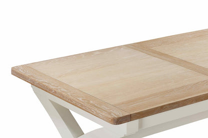 Papaya Foxington 180cm-240cm Cross Leg Extending Dining Table features a solid natural oak wood table top with extension leaves hidden within the table
