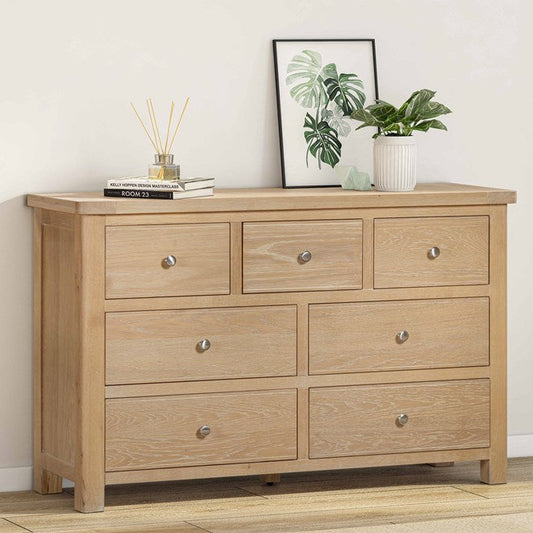 Papaya Foxington 7 drawer chest crafted from solid natural oak features 3 top drawers, 2 middle drawers and 2 lower drawers all with silver coloured metal drawers knobs