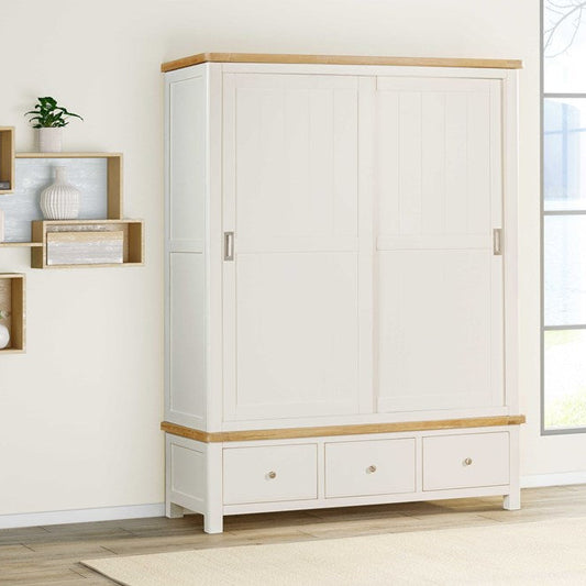 Papaya Foxington Large Wardrobe features 3 lower storage drawers and 2 sliding doors painted in an off white colour with a natural oak wood trim and silver coloured handles and drawer knobs