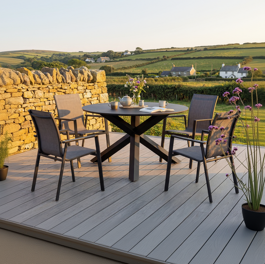 Royal Garden Catala 4 Seater Dining Set features 4 stackable aluminium dining chairs with textilene fabric, and a generous round table with cross leg design, in a sleek charcoal grey finish 