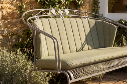 Royal Garden Elegance 2 Seater Bench with Green padded cushion, features stylish curved arms, a mesh seat base and elegant detailing to the metal frame 