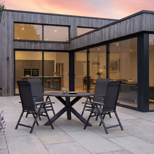 Royal Garden Vidoo 4 Seat Round Dining Set is a sleek contemporary collection featured a dark grey charcoal coloured round dining table with cross leg base, and 4 multi position reclining chairs that can fold when not in use