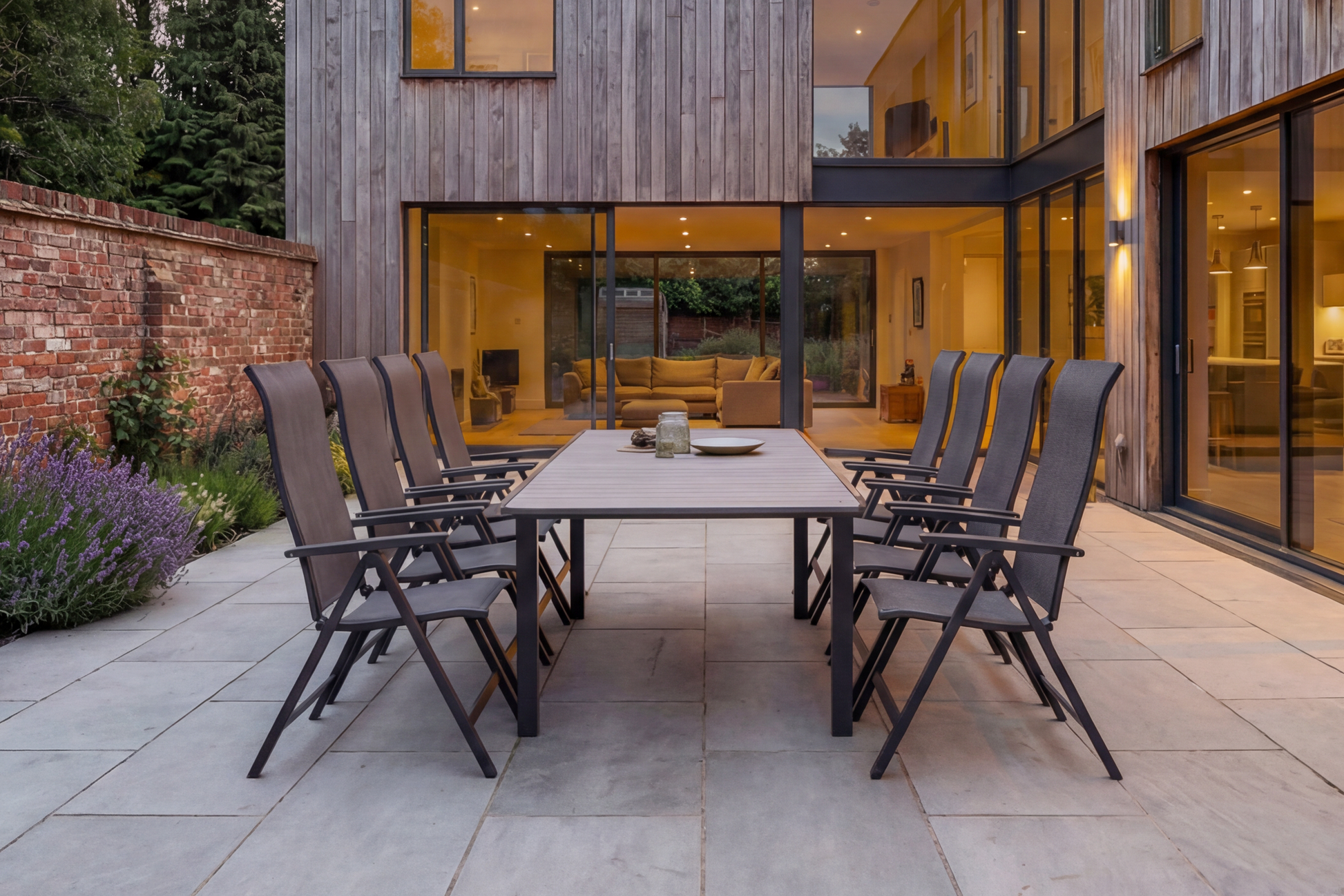 The Royal Garden Vidoo 8 Seat Extending Dining Set features an extending dining table and 8 multi position reclining chairs in a sleek dark grey charcoal colour