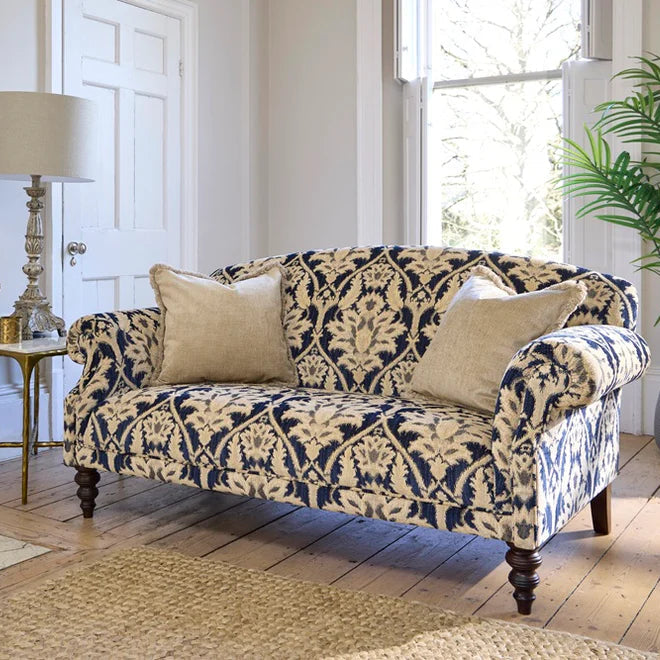 Tetrad Tallis Petit Sofa in Enigma Indigo damask upholstery with deep filled cushions, scrolled armrests and dark wood feet