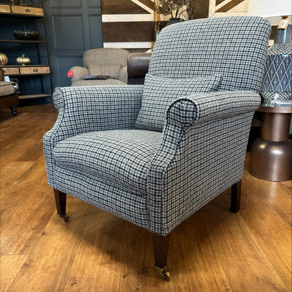 Tetrad Bowmore Ebony Hounds Harris Tweed accent armchair, in charcoal and cream houndstooth check with dark brown wood legs and brass castors to the front