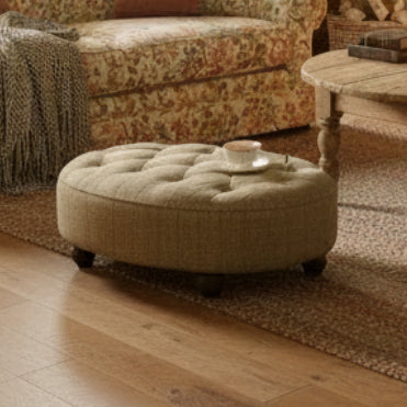 Tetrad Caledonian Footstool in Bracken Herringbone patterned upholstery with deep button tufting and turned wood feet 