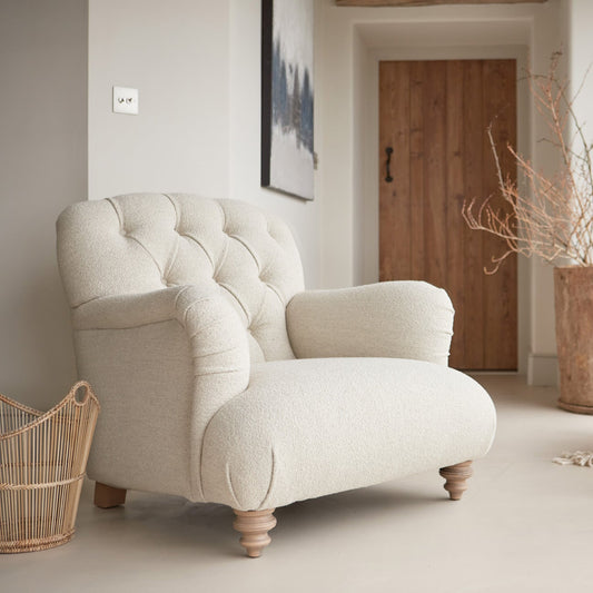 Tetrad Duffel Chair in Bottega Natural Fabric shown complete in a furnished room.
