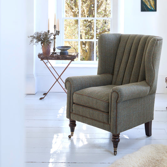 Tetrad Dunmore Chair in Loden Herringbone Fabric shown complete in a furnished room.