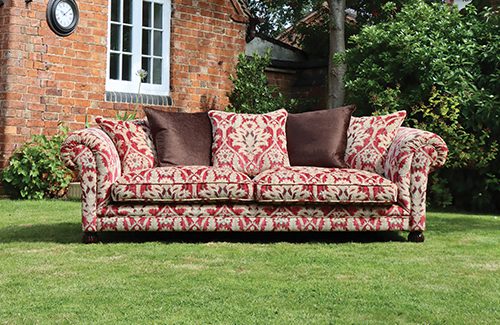 Tetrad Elgar Grand Sofa in Enigma Claret Fabric with curved armrests, dark wood legs, deep filled seat cushions and scatter backs