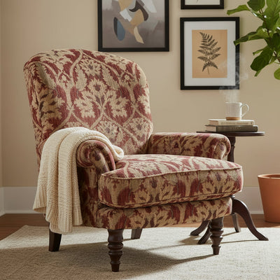 The Tetrad Elgar Highback Chair is upholstered in Enigma Claret Damask Fabric in rich red and gold tones with dark wooden legs