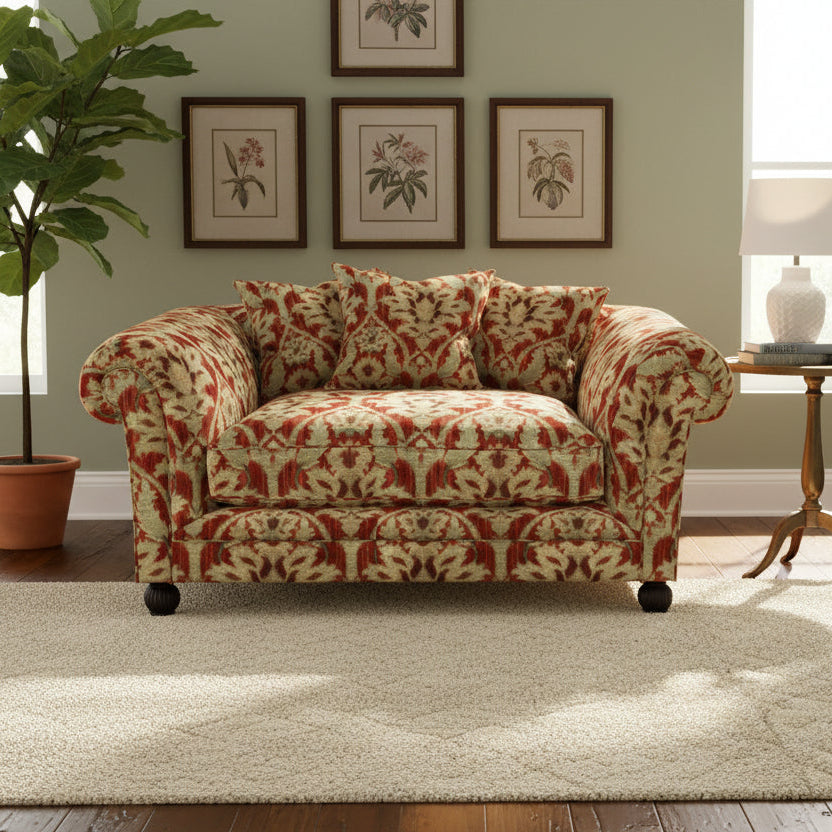 Tetrad Elgar Snuggler Sofa can seat 1-2 people and is upholstered in Enigma Claret Fabric, features curved armrests, deep filled seat cushion and scatter backs, and dark wood legs
