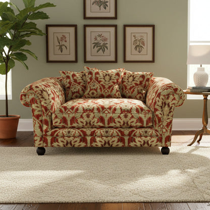 Tetrad Elgar Snuggler Sofa can seat 1-2 people and is upholstered in Enigma Claret Fabric, features curved armrests, deep filled seat cushion and scatter backs, and dark wood legs